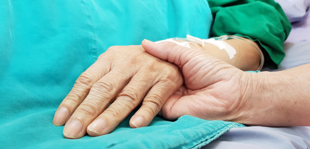 close up of elderly hand, end of life care.