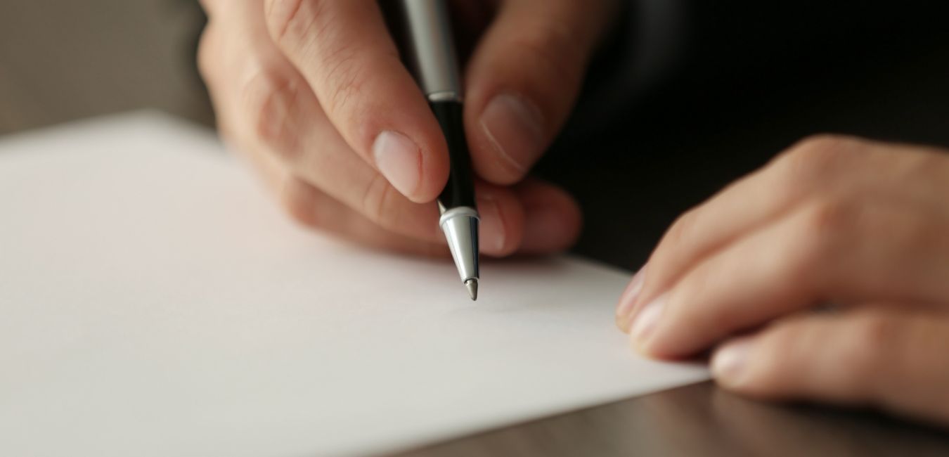 Person writing down on paper, funeral pre planning